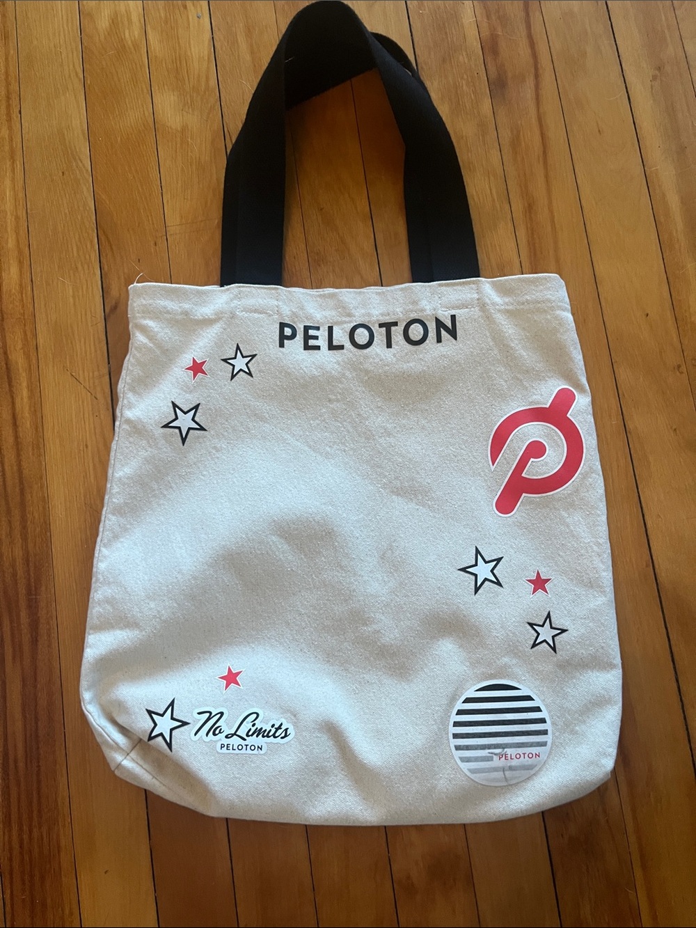 Peloton Beige Canvas Tote with Black Handles and Red Accents